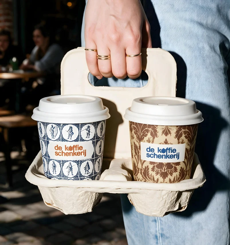 A moulded carrier holding two cups, carried past the terrace