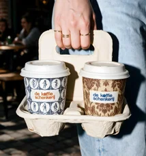 A moulded carrier holding two cups, carried past the terrace