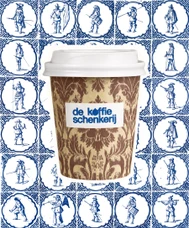 Damask-patterned cup against a wall of Delft blue figure tiles