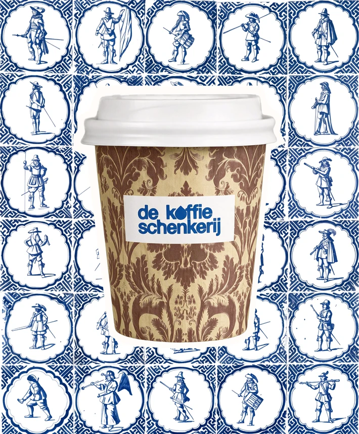 Damask-patterned cup against a wall of Delft blue figure tiles