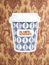 Delft tile cup against a brown damask wallcovering
