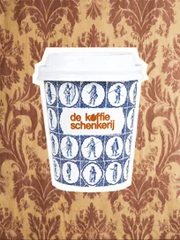 Delft tile cup against a brown damask wallcovering