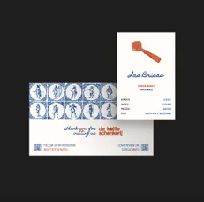 Delft tile business cards fanned out with a coffee card