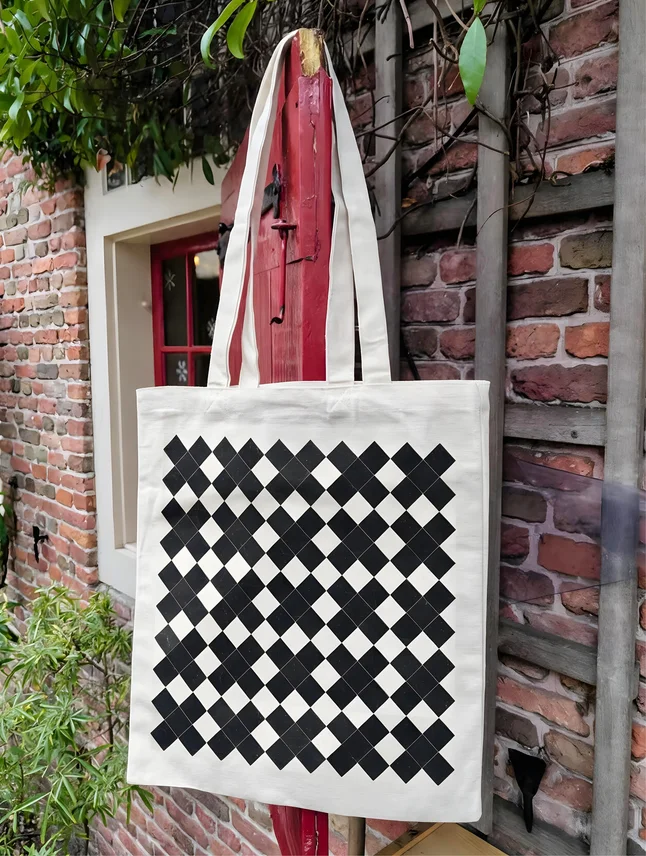 A checkerboard tote against the brick wall and red shutter