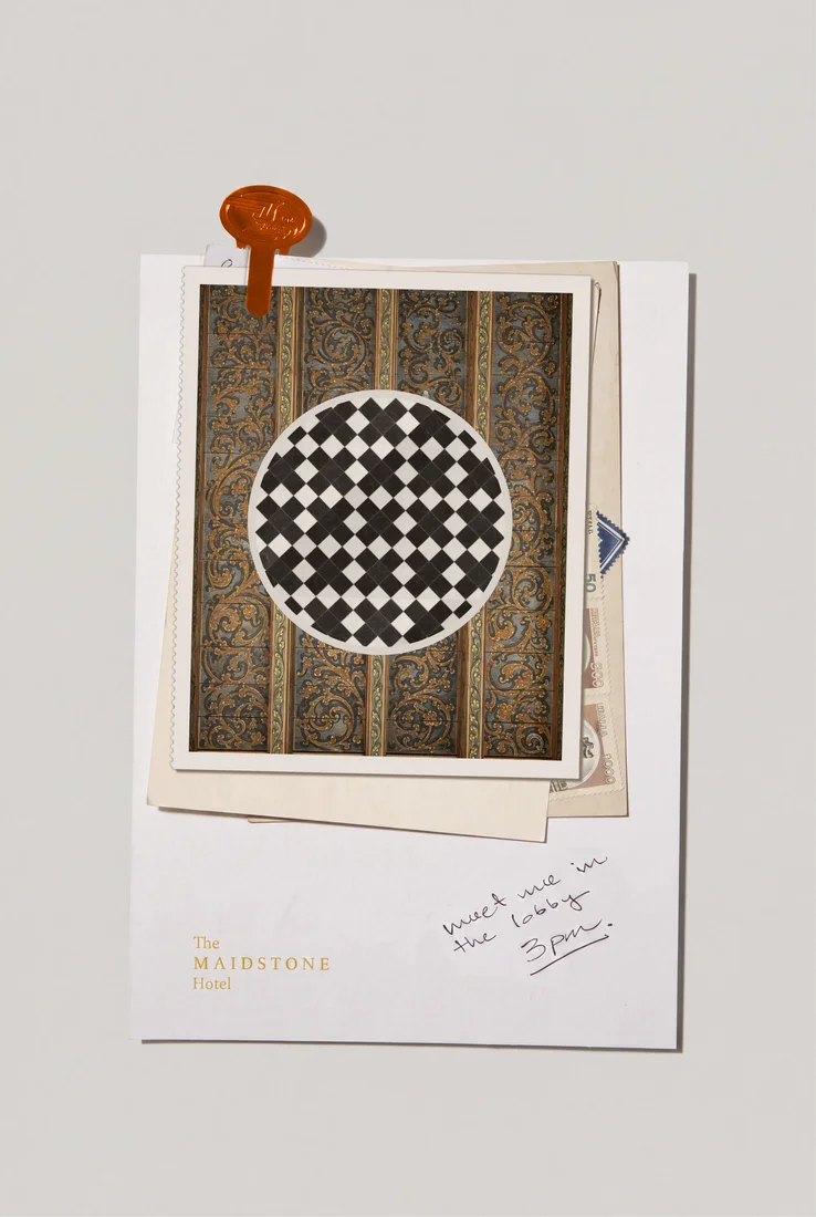 A framed checkerboard print on a wall